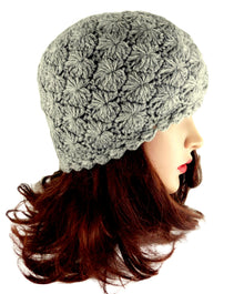 Gray crocheted beanie on a mannequin head with brown hair against a white background